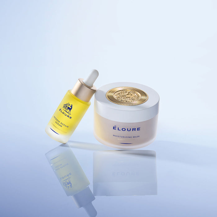 Éloure Intense Repair Serum beside the Moisturizing Mask on a reflective surface